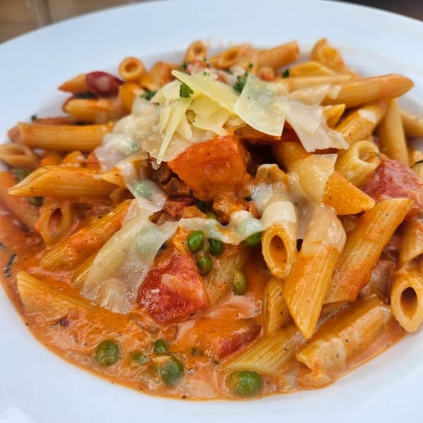 Babymoon Cafe's penne pasta with creamy tomato sauce, peas, diced tomatoes, and shaved Parmesan.