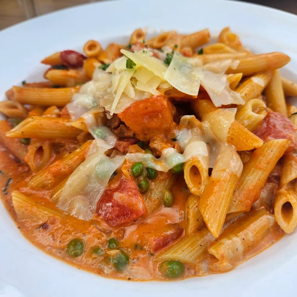 Babymoon Cafe's penne pasta with creamy tomato sauce, peas, diced tomatoes, and shaved Parmesan.